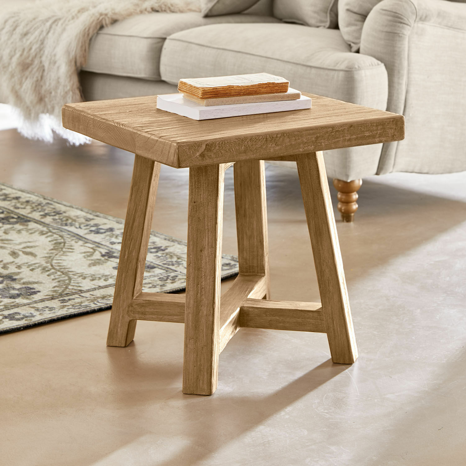 Tavolino di complemento Eldonbury Tavolino quadrato in legno naturale davanti a un divano beige e un tappeto decorativo