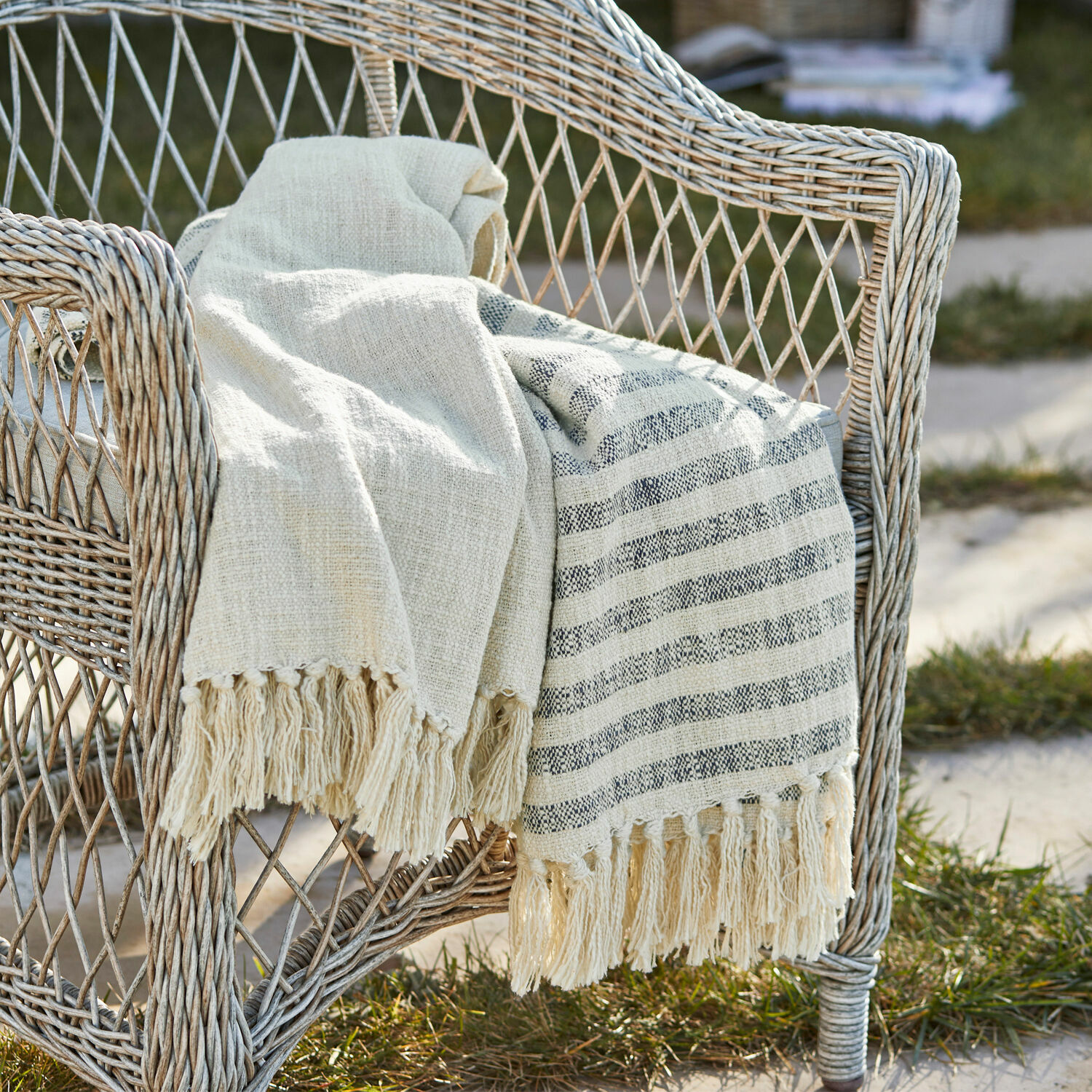 Coperta Marpent Coperta beige in cotone con frange su sedia in vimini in giardino, decorazione e comfort