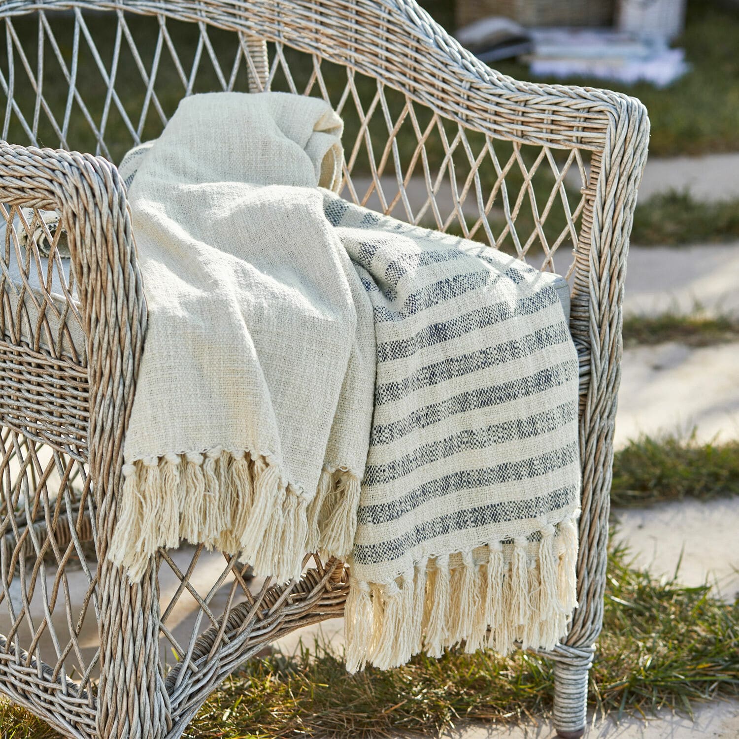 Coperta Marpent Coperta beige in cotone con frange su sedia in vimini in giardino, decorazione e comfort