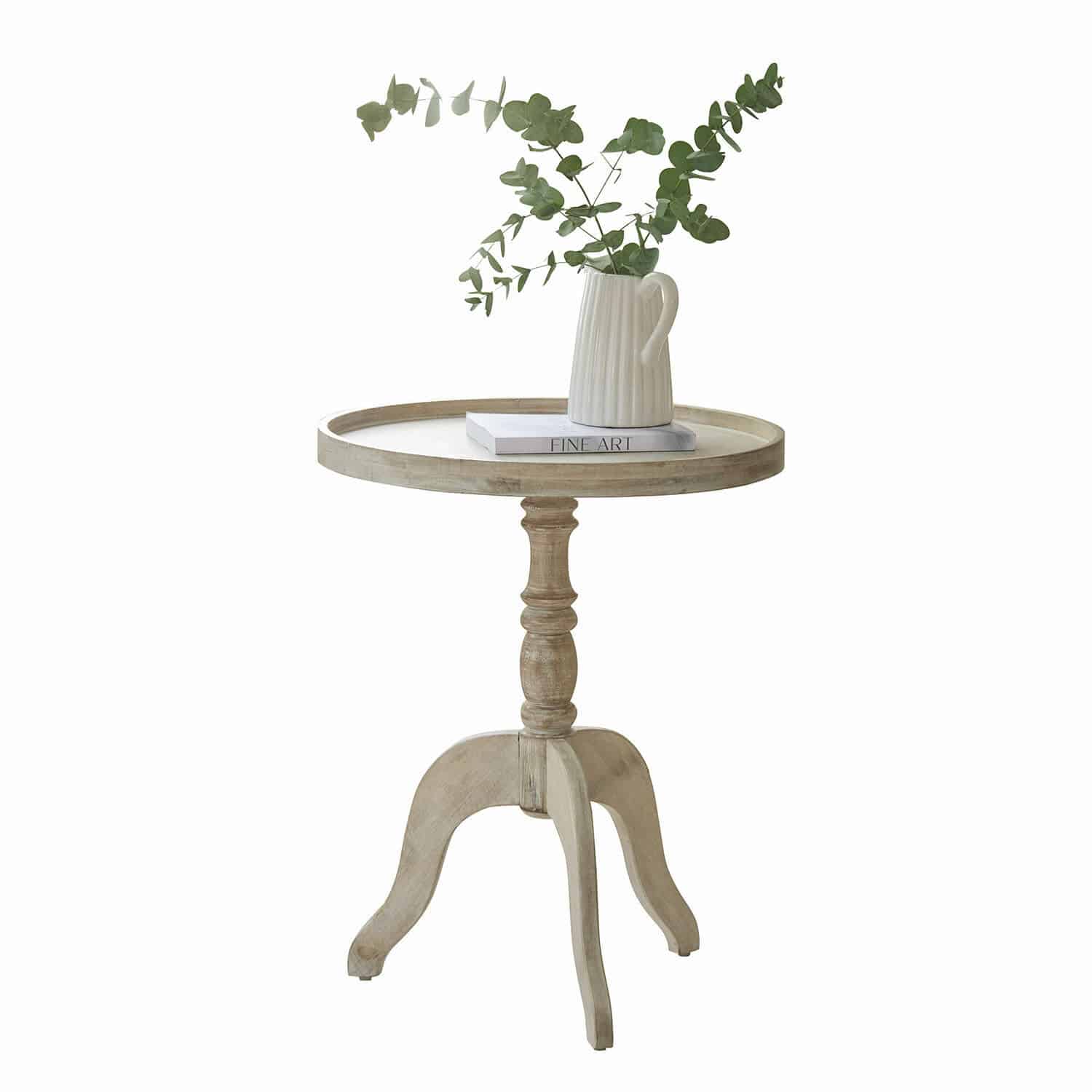 Tavolino di complemento Brookdale Tavolino rotondo in legno chiaro con brocca in ceramica e foglie verdi sopra