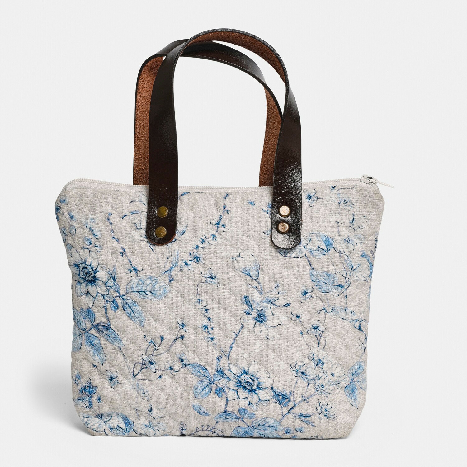 Borsa Vailenne Borsa trapuntata beige con motivo floreale blu e manici in pelle nera, accessorio alla moda