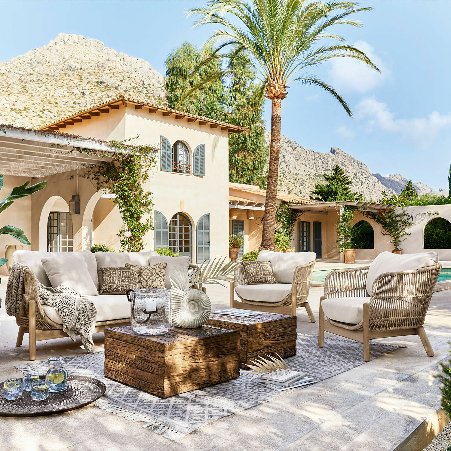 Salottino FSC®-100% Belvidere Set di mobili da esterno con cuscini beige e tavolo in legno su terrazza vicino alla piscina