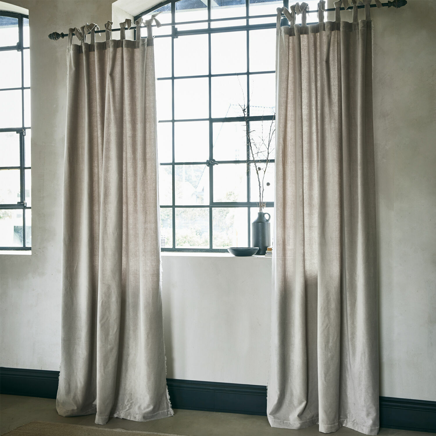 Tenda Bagujo Tende beige in tessuto naturale davanti a una grande finestra, decorazione d'interni elegante e morbida.