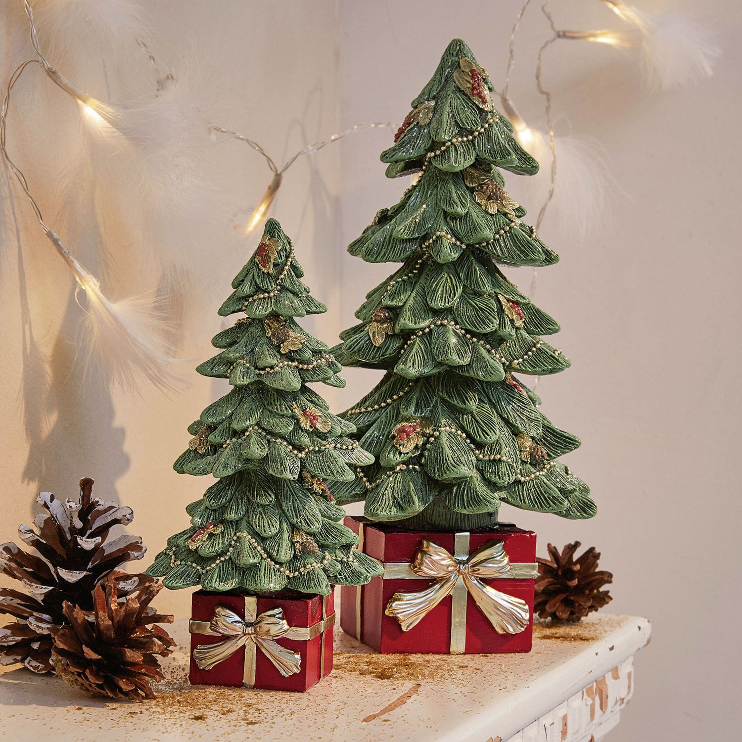 Coppia di alberelli decorativi Verne Due alberi di Natale decorativi verdi in materiale su scatole rosse con fiocchi dorati, decorazione natalizia
