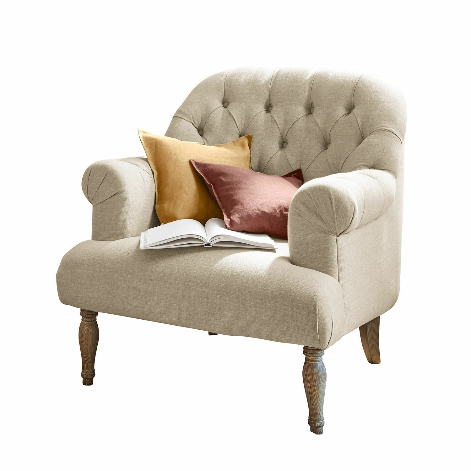 Poltrona Shambrook Divano beige imbottito con gambe in legno, cuscini colorati e libro aperto per soggiorno accogliente