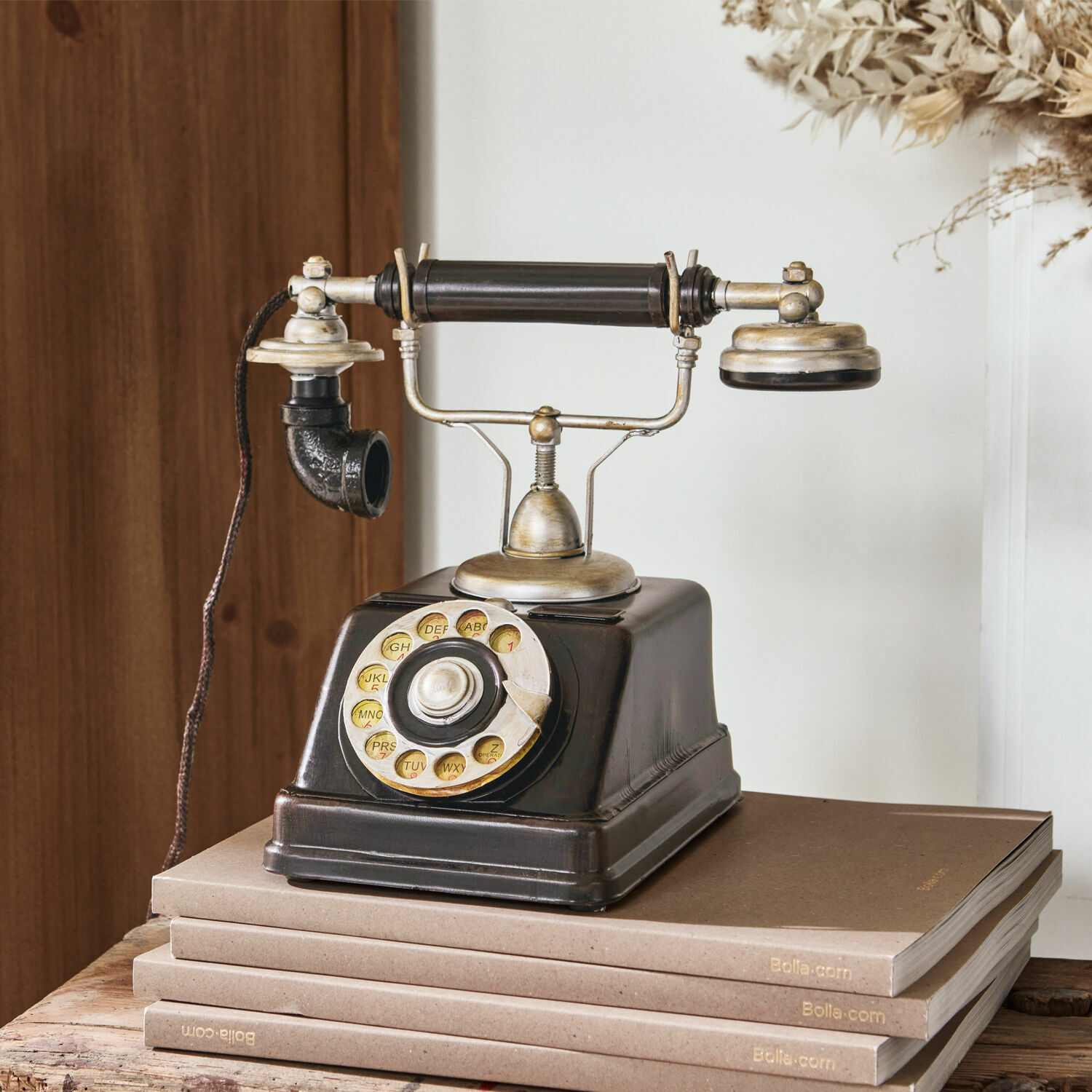 Telefono decorativo Upavon Vecchio telefono nero con disco rotante e parti metalliche su pila di libri marroni