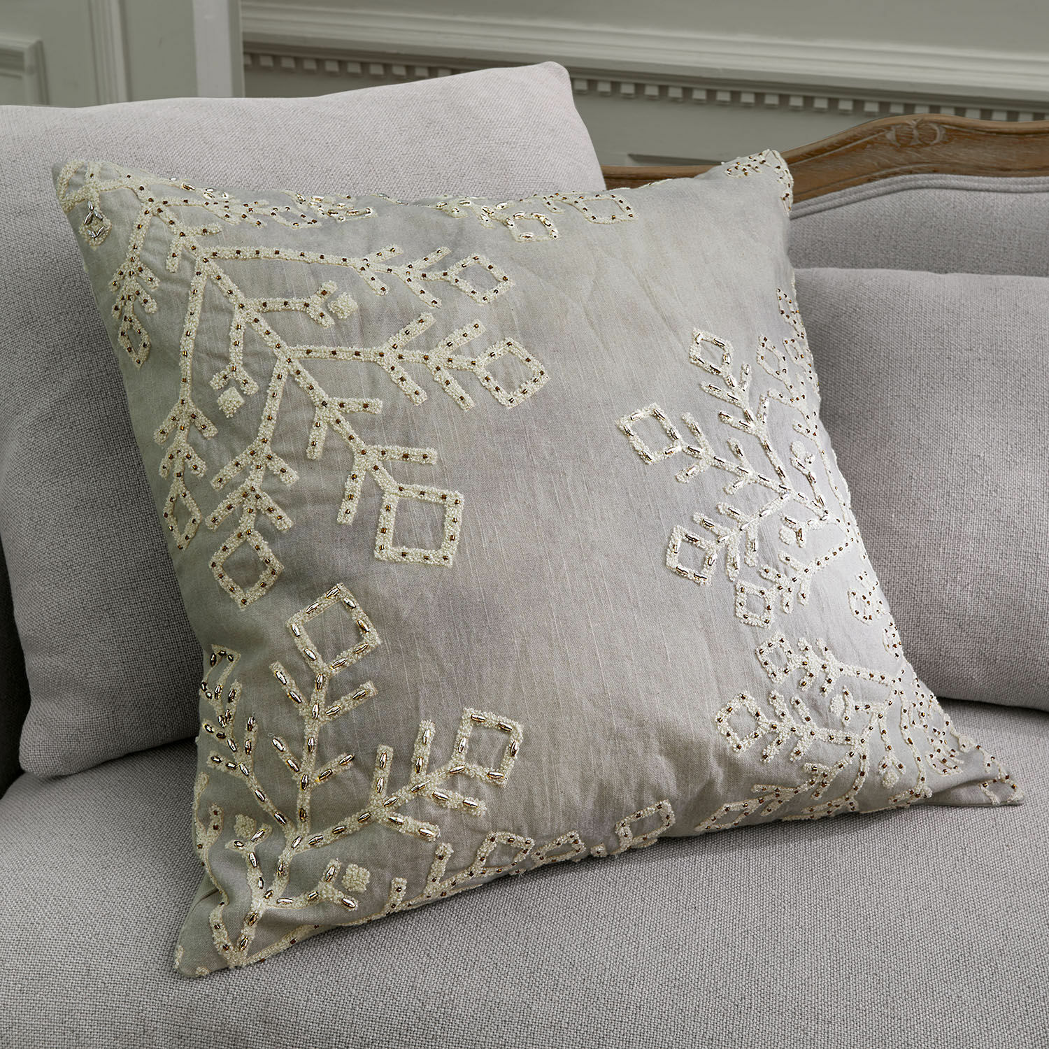 Copricuscino Halezan Cuscino decorativo beige con ricamo e paillettes su divano grigio chiaro, tessile per interni