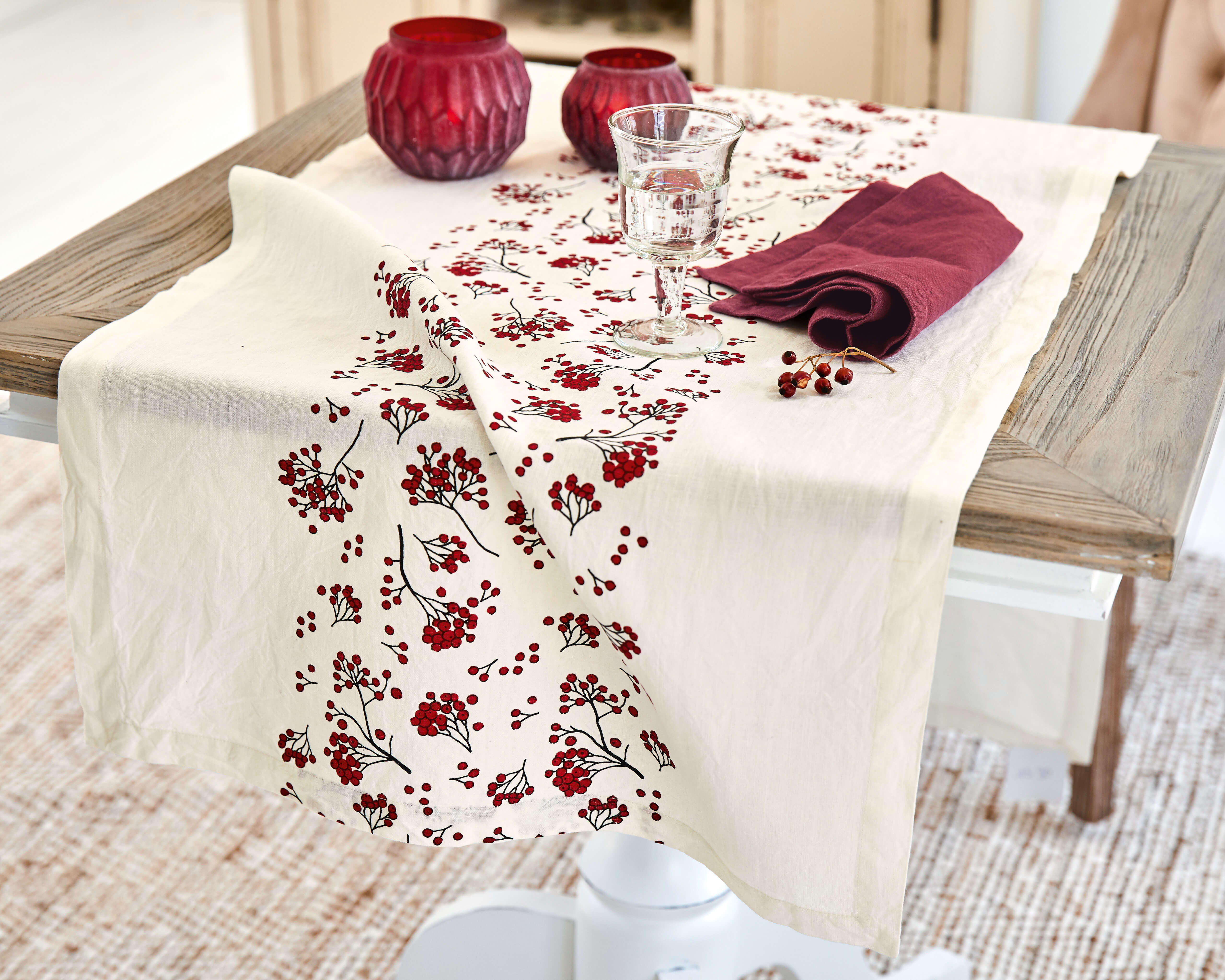 Runner da tavola in cotone crema con motivo di bacche rosse e portacandele decorativi