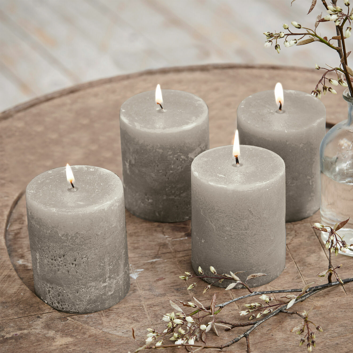 Set di 4 candele Virrans Set di quattro candele di cera grigie su tavolo in legno con decorazione floreale, decorazione casa