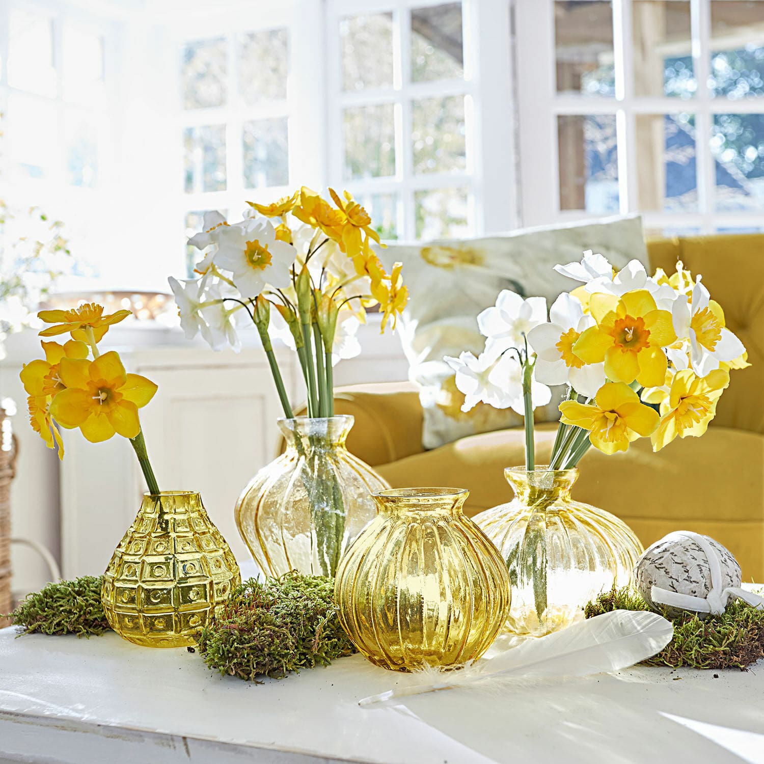 Mazzo di 12 fiori decorativi Misapina Set di vasi in vetro giallo con fiori gialli e bianchi su tavolo bianco in ambiente luminoso