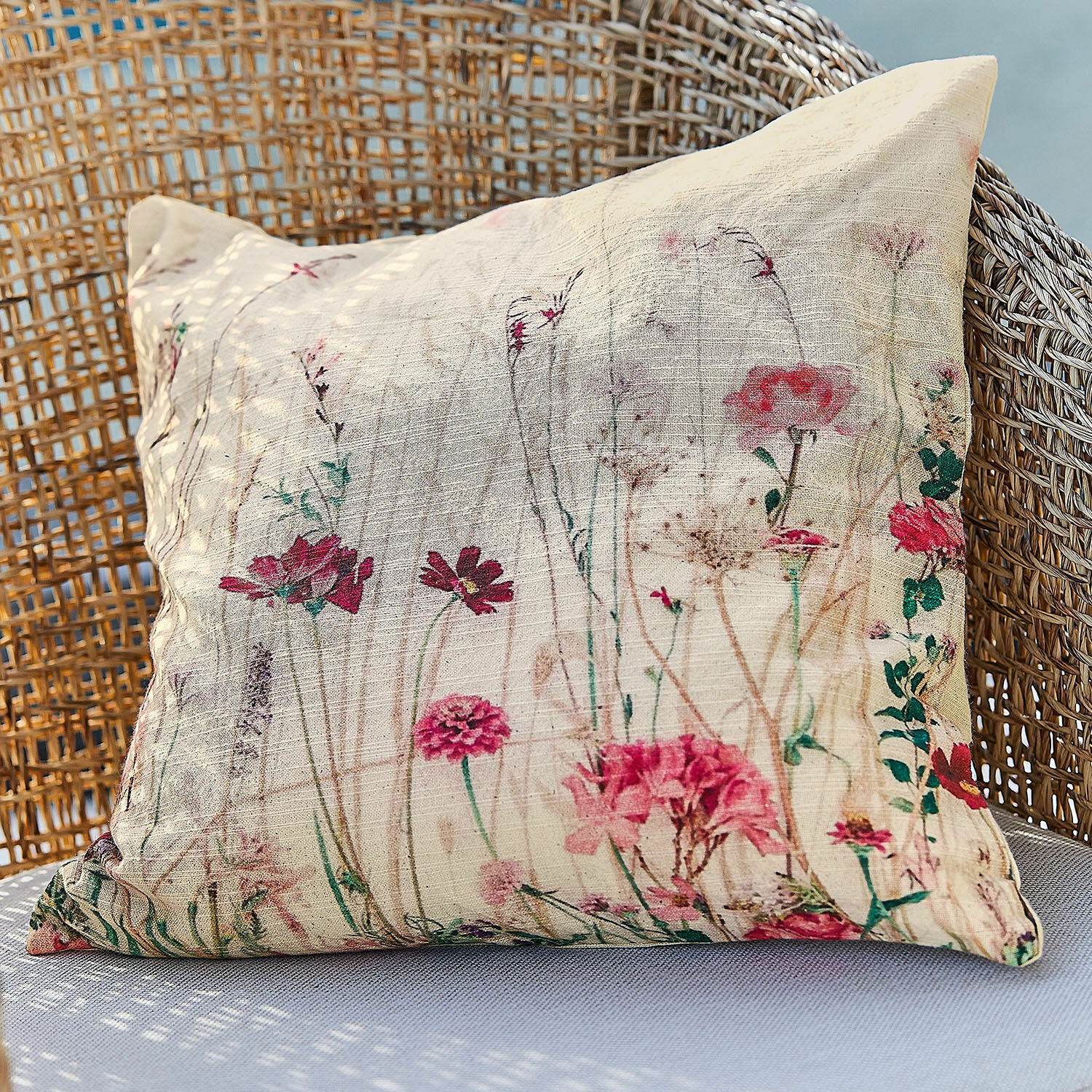 Copricuscino Briovene Cuscino beige in tessuto naturale con stampa floreale su poltrona in vimini, decorazione casa