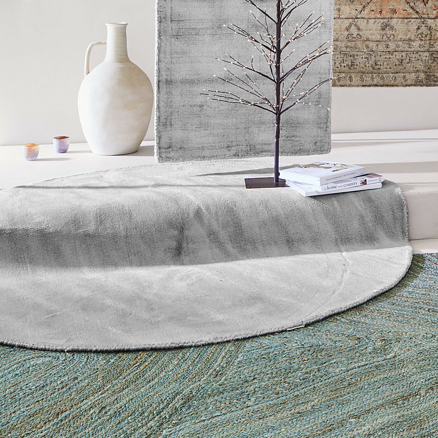 Tappeto Mariselle Tappeto rotondo grigio in materiale morbido con vaso decorativo e libri in un interno moderno