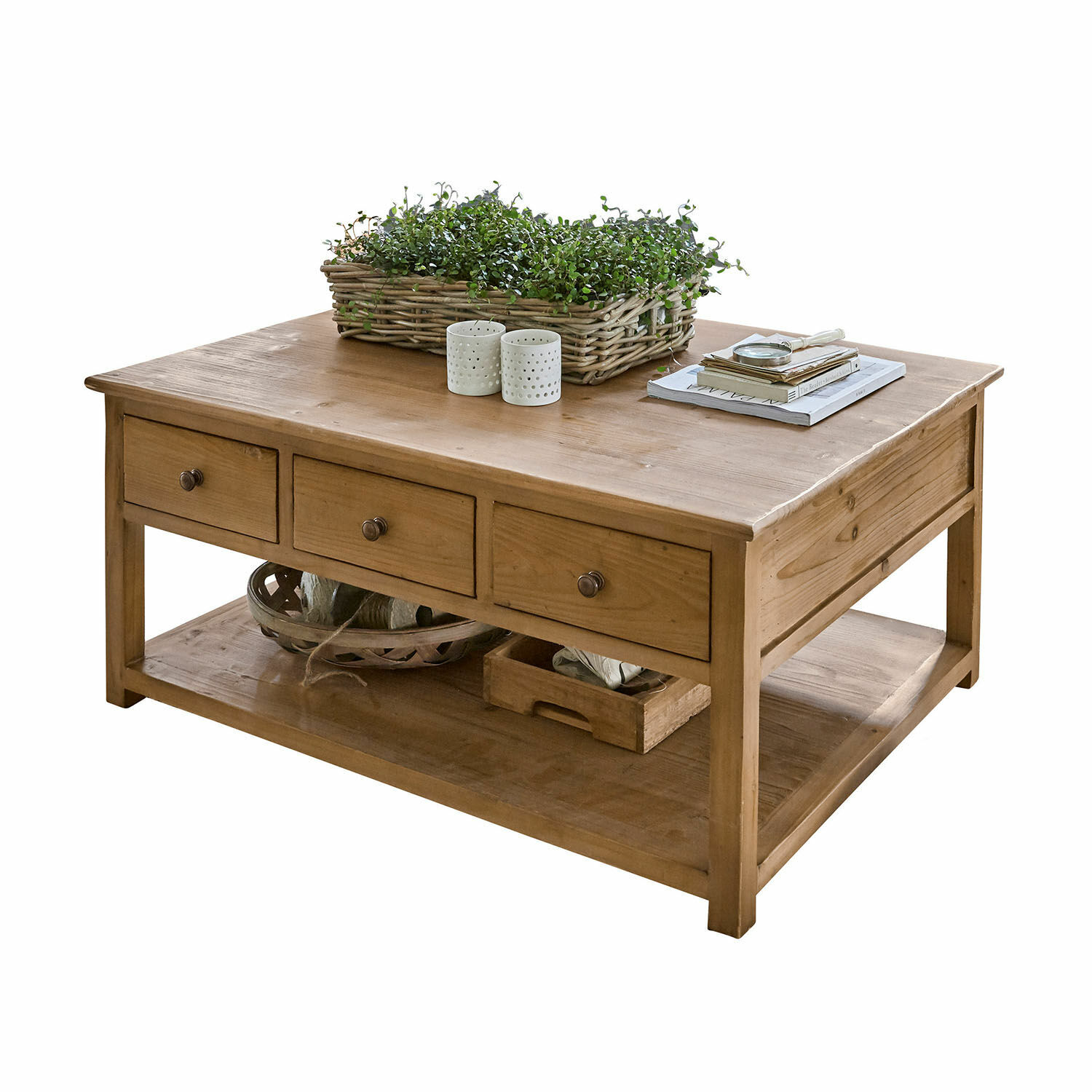 Tavolino da salotto Etienne Tavolino da salotto in legno naturale con tre cassetti e ripiano inferiore, decorato con piante e libri