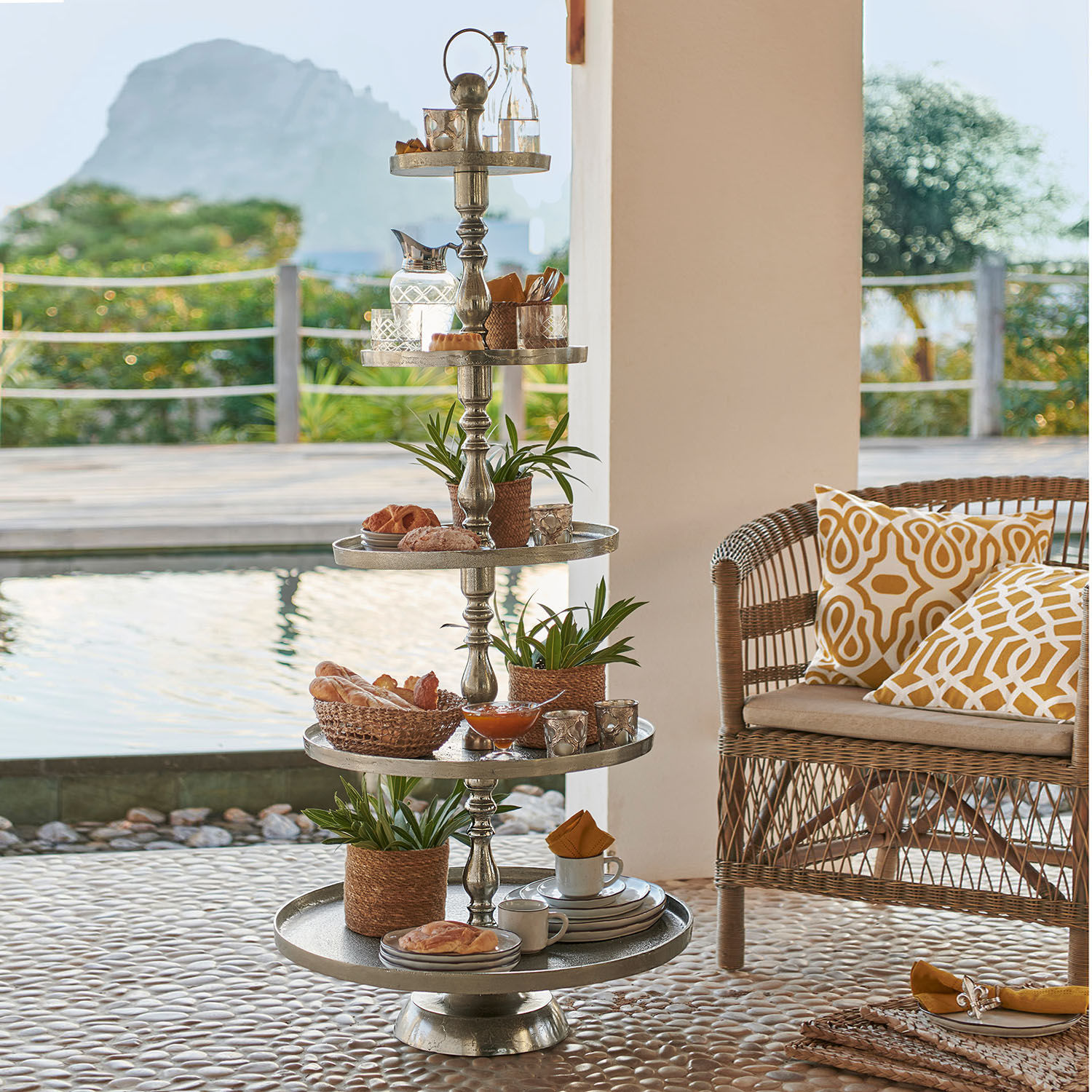 Alzata Magonie Porta dolci metallico a cinque livelli con decorazioni e snack su terrazza vicino alla piscina