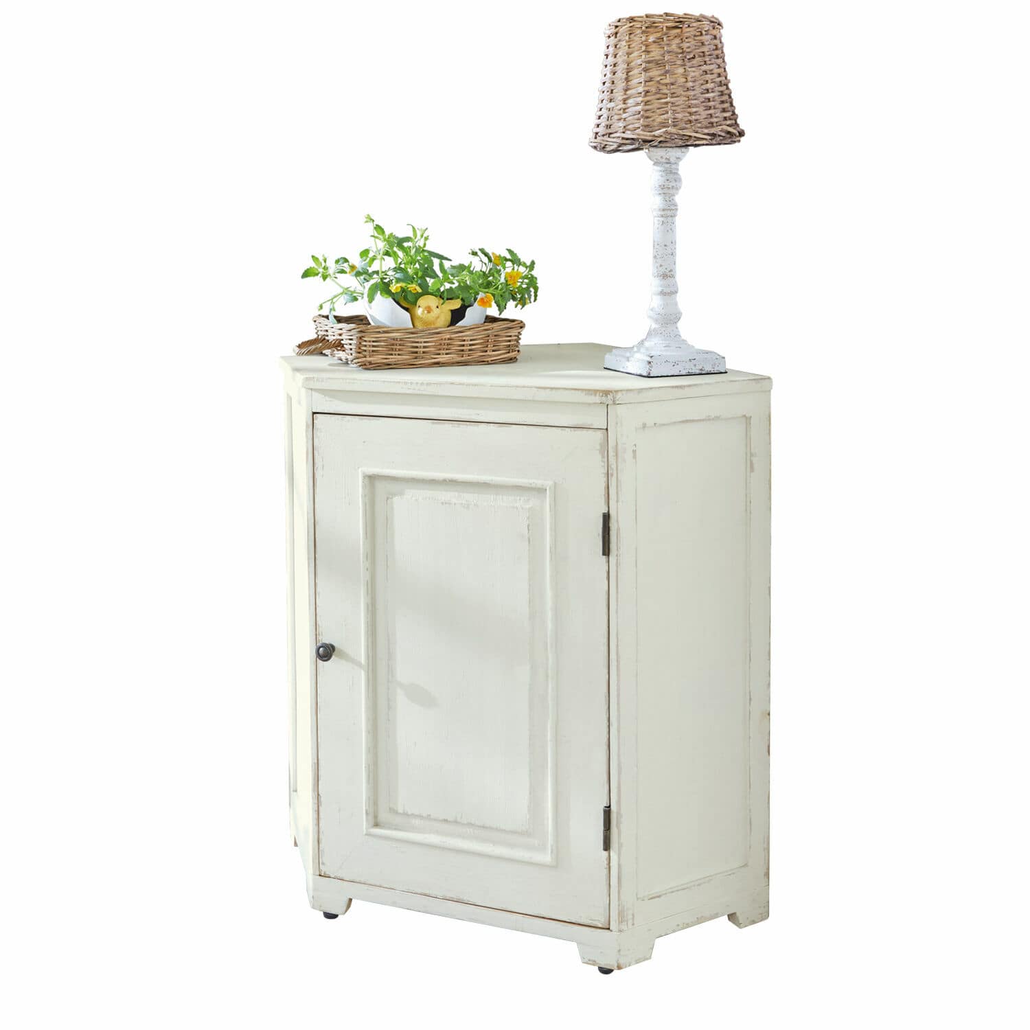 Comò angolare Yurielka Mobiletto bianco in legno con una porta, lampada con paralume in vimini e cesta con piante sopra