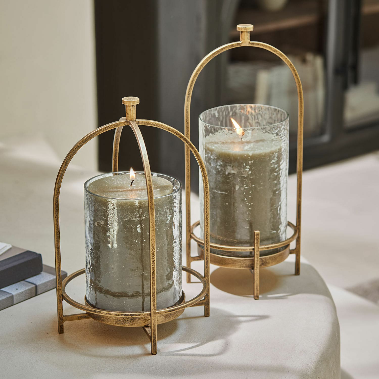 Coppia di portalumini Biserre Due portacandele in vetro con struttura metallica color oro antico e candele grigie decorative