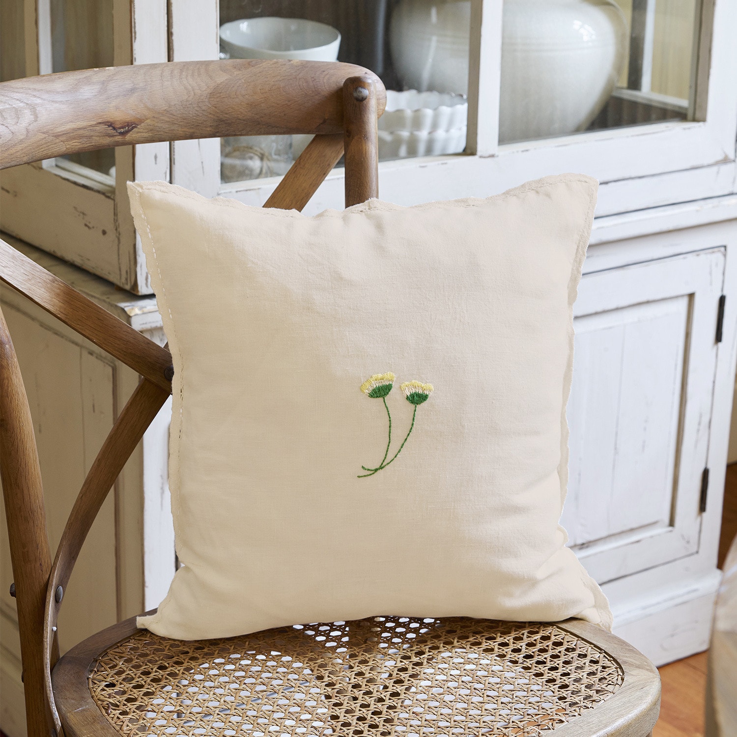Copricuscino Dijon Cuscino beige in lino con ricamo di fiori gialli su sedia in vimini per decorazione d'interni