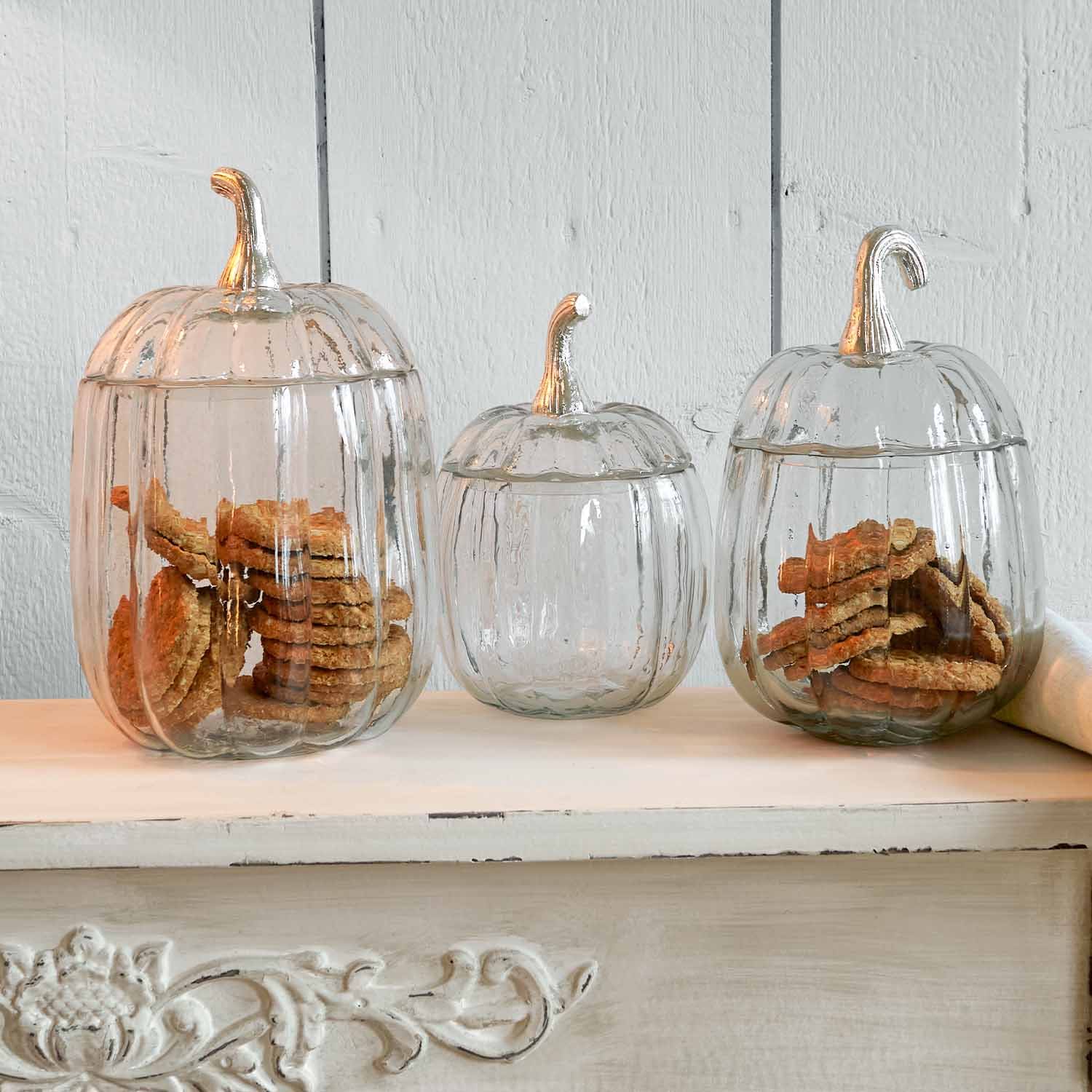 Contenitori in vetro a forma di zucca con coperchi argentati, ideali per conservare biscotti