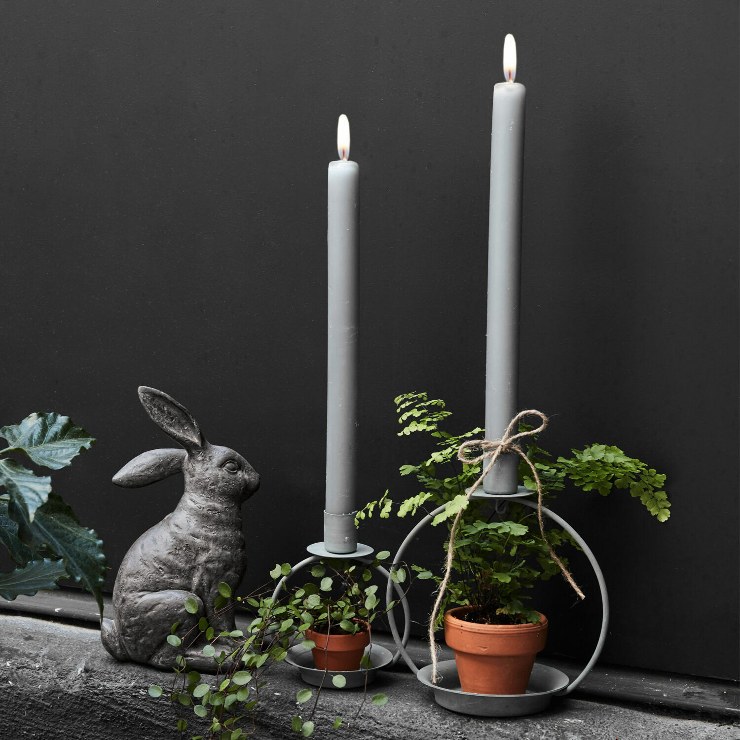 Coppia di portacandele Nirrat Portacandele in metallo grigio con candele grigie, piante verdi in vaso e decorazione con coniglio in pietra