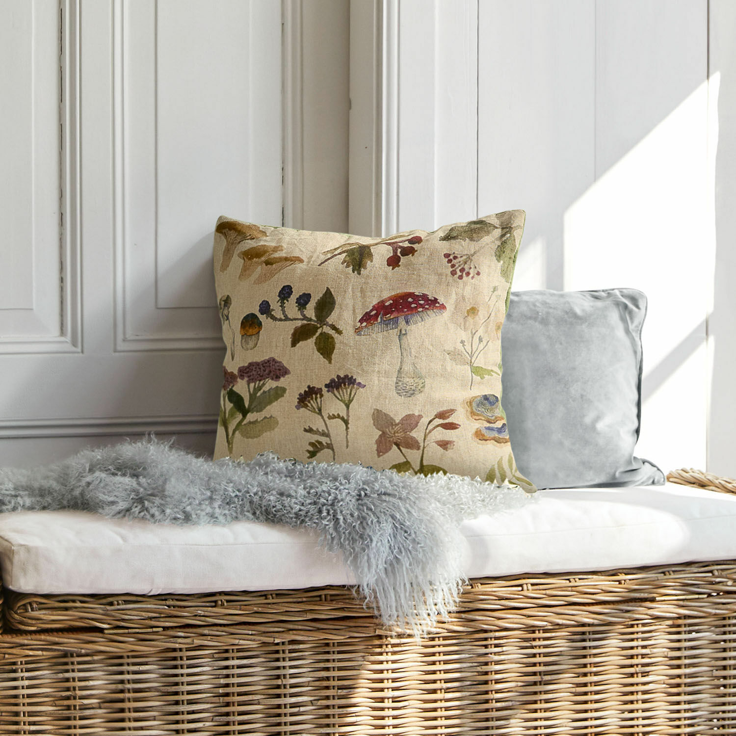 Copricuscino Selarune Cuscino decorativo in lino con motivo vegetale naturale su panca in vimini chiaro