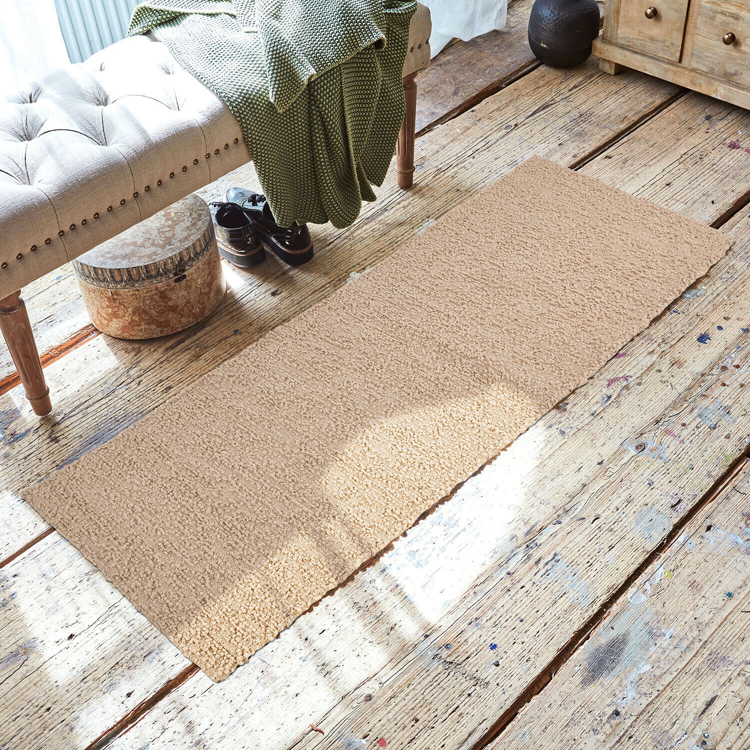 Corridore Kaleema Tappeto beige in materiale morbido su pavimento in legno in ambiente accogliente con panca e coperta verde