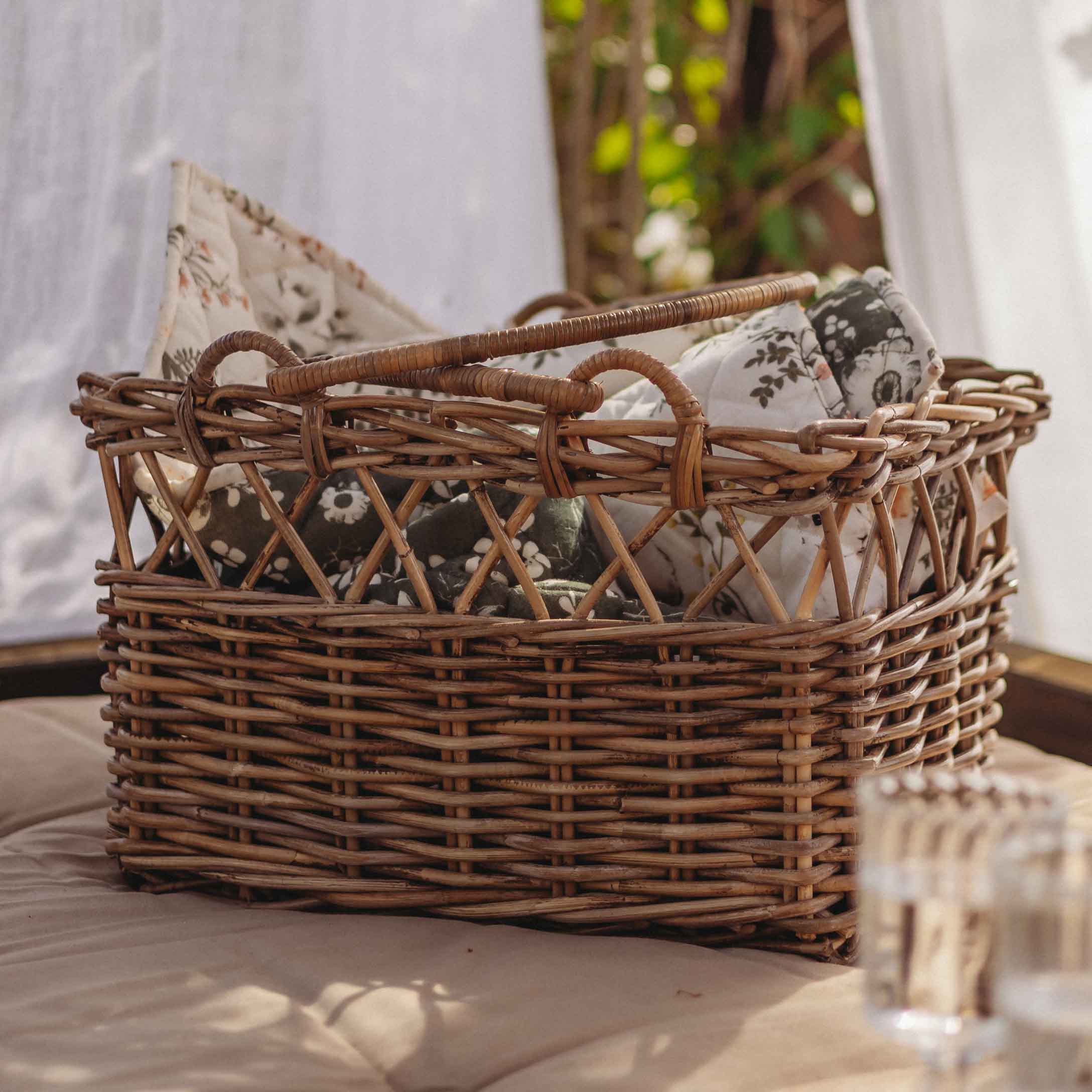 Cesto in vimini marrone naturale con cuscini floreali, decorazione e contenitore per la casa