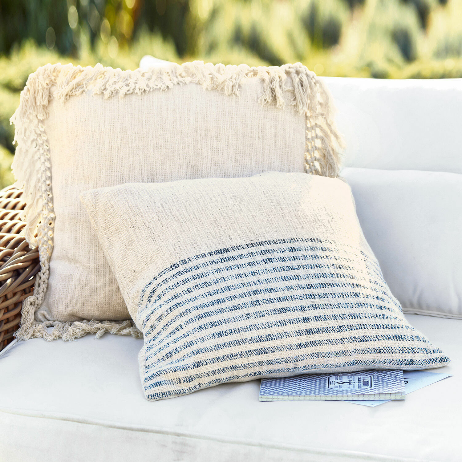 Coppia di copricuscini Marpent Cuscini decorativi in lino beige con frange e righe su divano bianco all'aperto