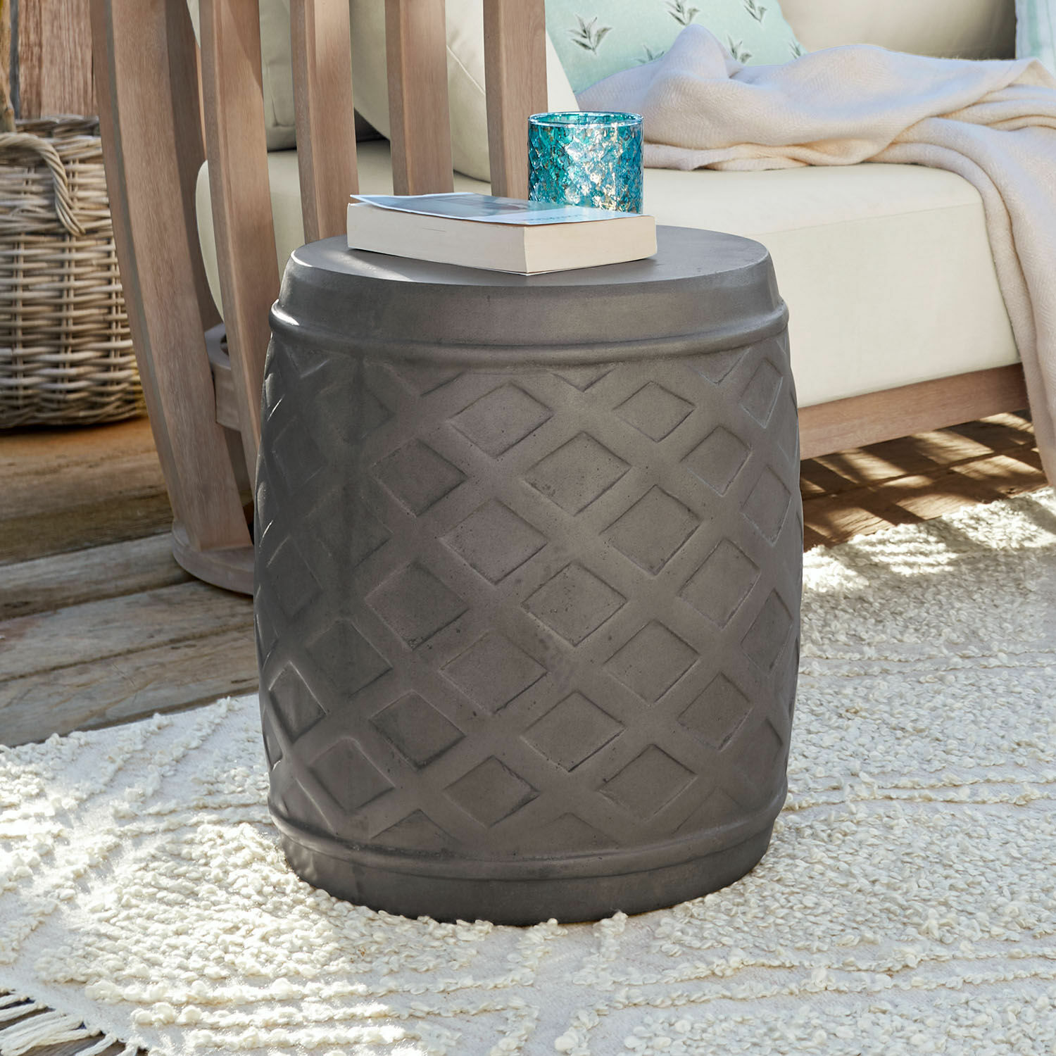 Sgabello Plévin Tavolino grigio in cemento con motivo geometrico su tappeto in soggiorno con mobili in legno