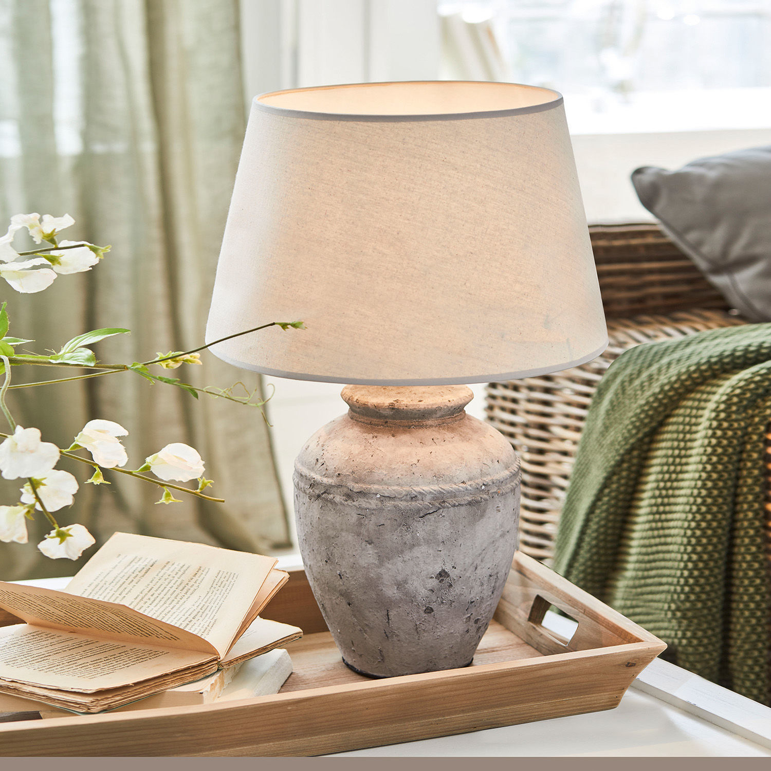 Lampada da tavolo Mosnay Lampada da tavolo in ceramica grigia con paralume beige su vassoio di legno in soggiorno